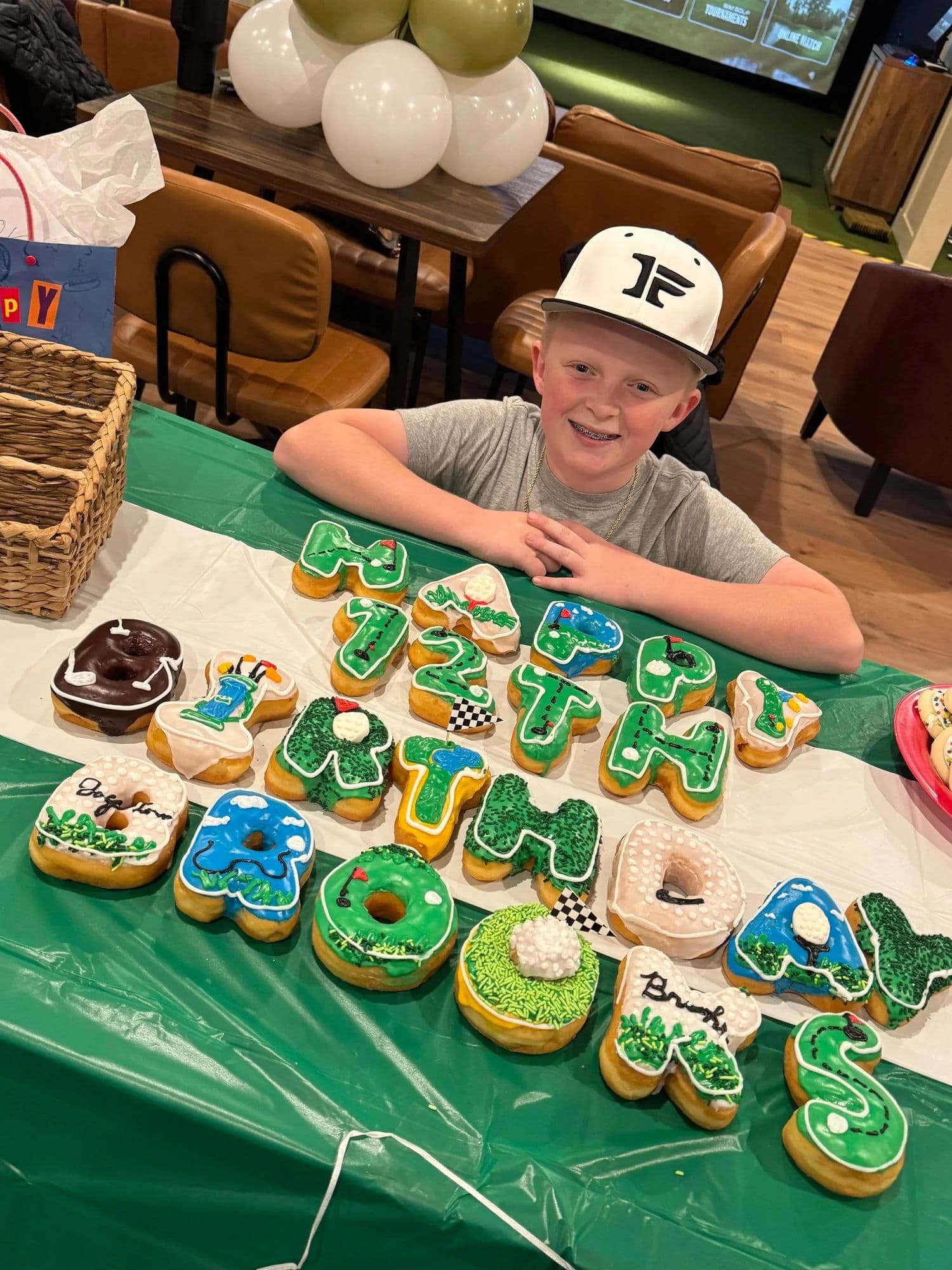 A birthday boy with custom party cookies at The Golf House