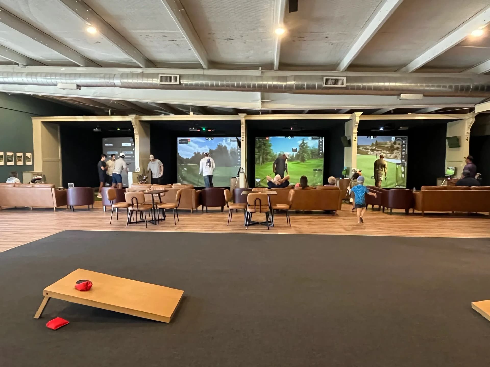 The open lounge and simulator bays at The Golf House