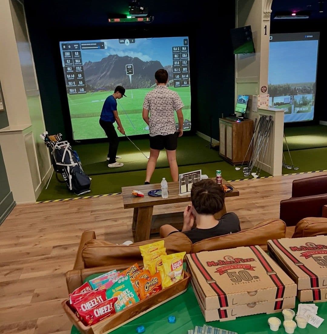 Friends with pizza and snacks in a simulator bay