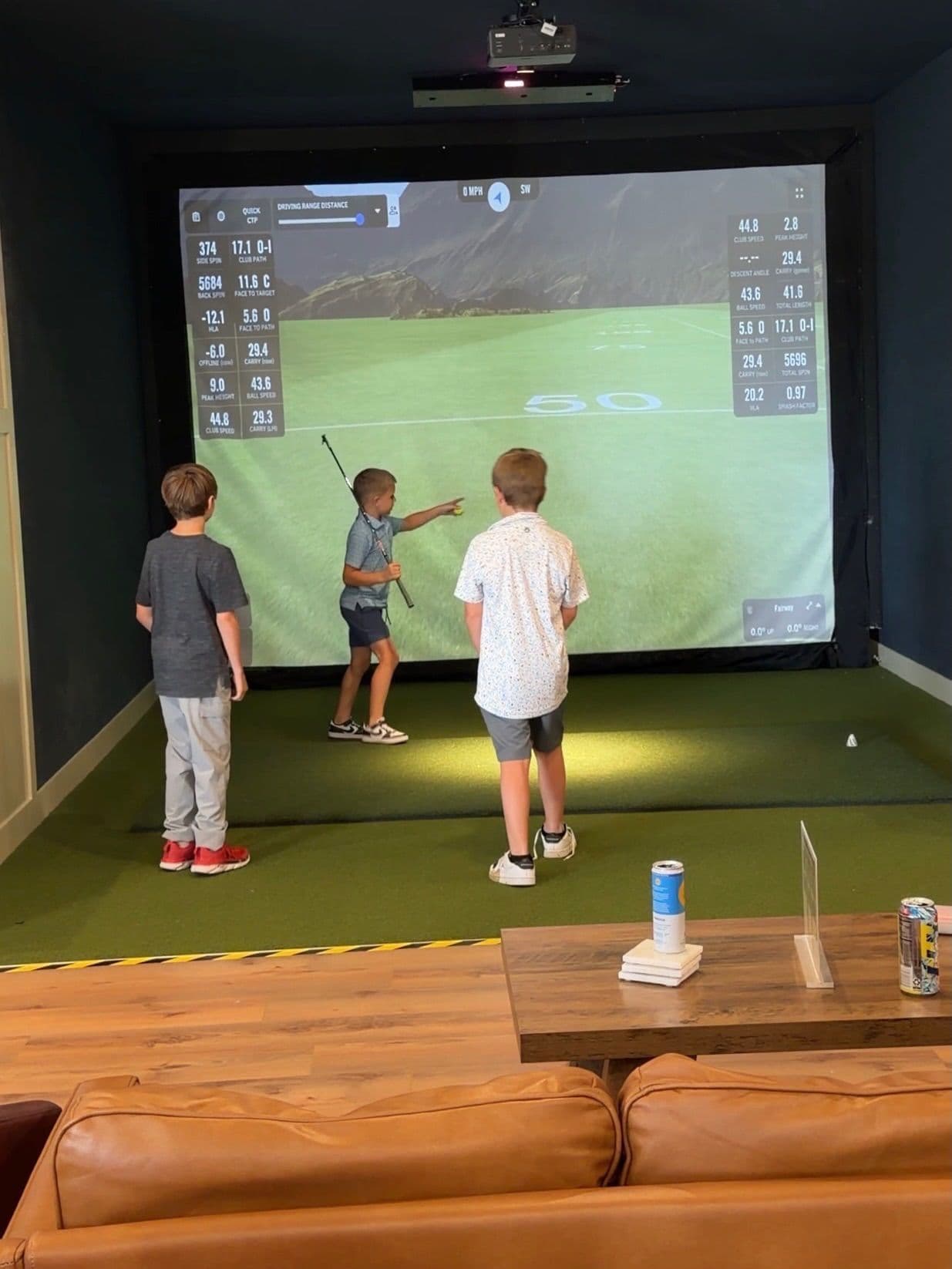 Kids lining up a shot on the simulator