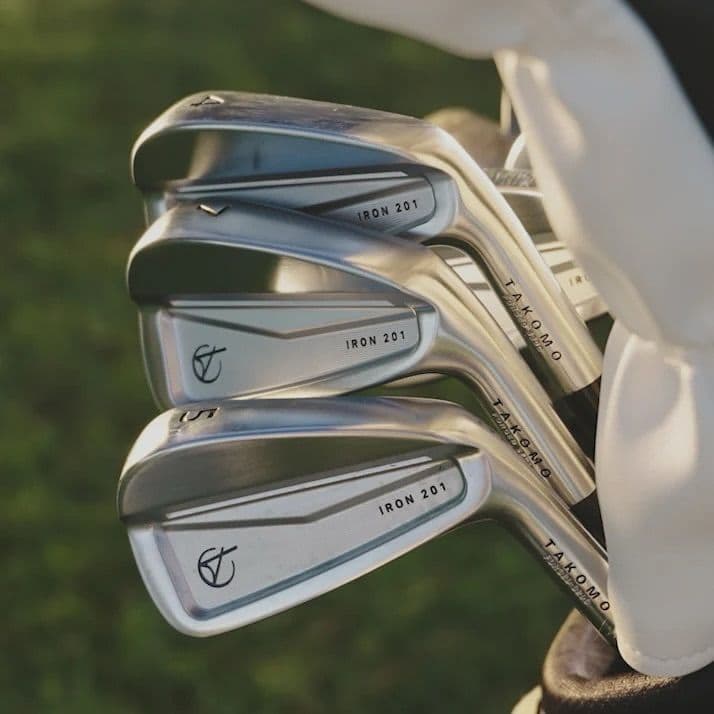 A close-up of Takomo Iron 201 club heads