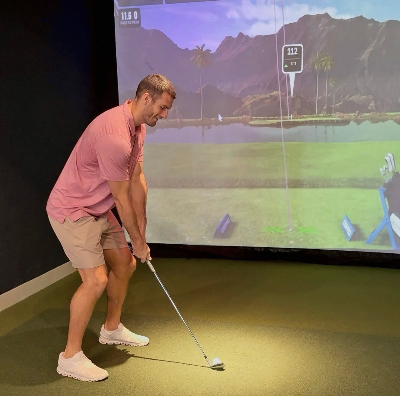 A golfer hitting into the simulator screen