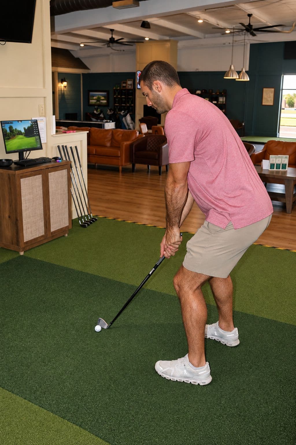 A golfer chipping on the turf