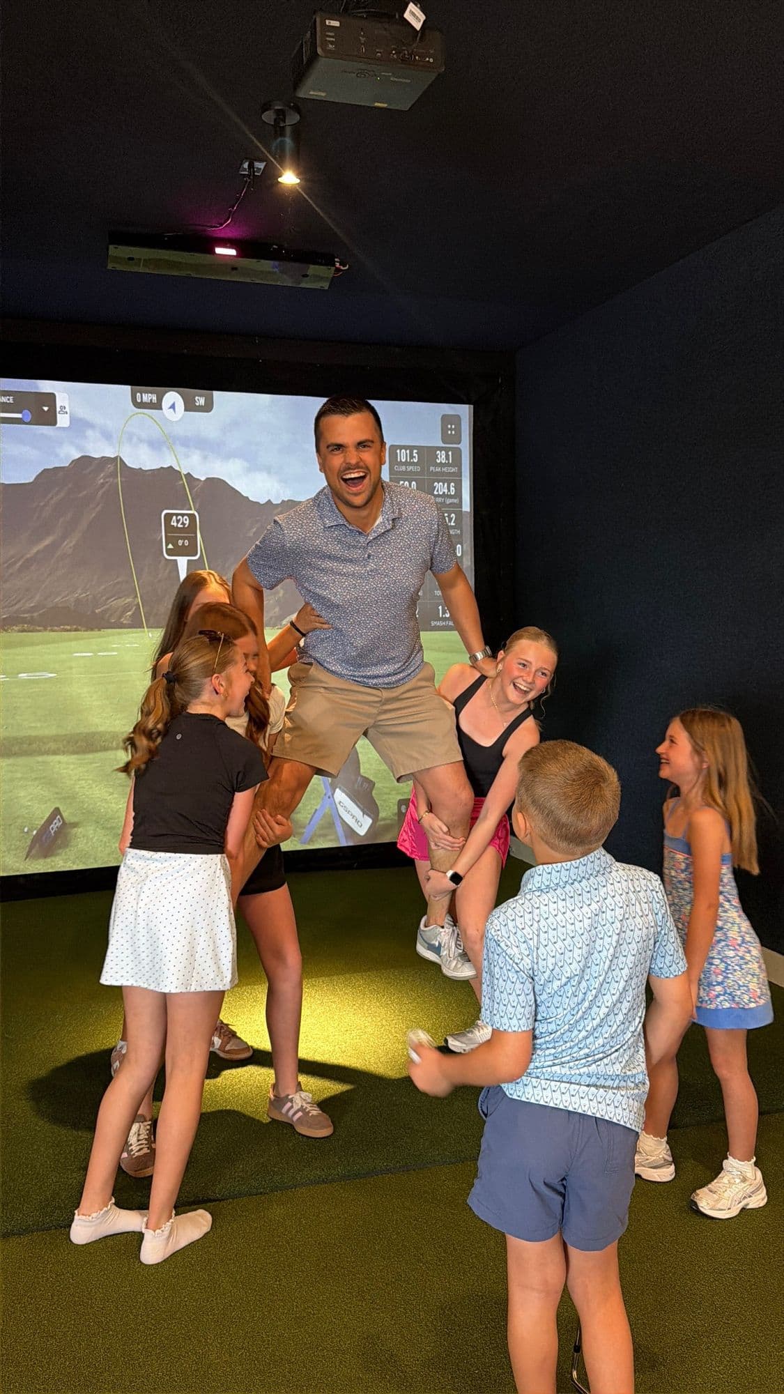 A celebratory moment in a simulator bay at The Golf House