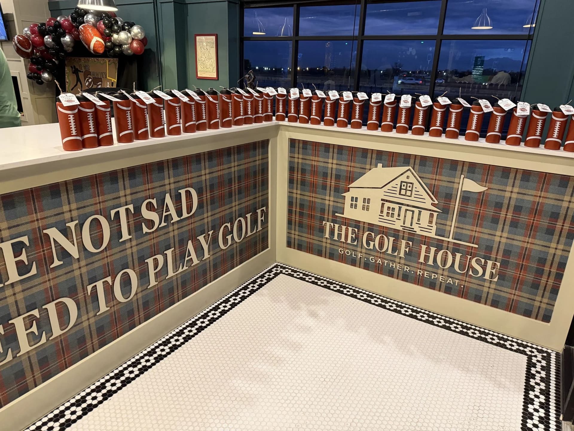 The Golf House branded plaid wall in the lounge