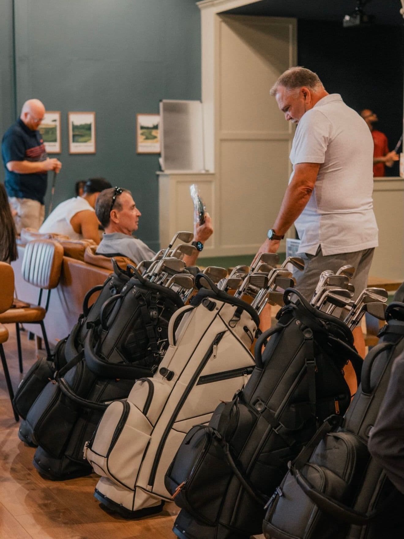 Golfers gathered with their bags in The Golf House lounge