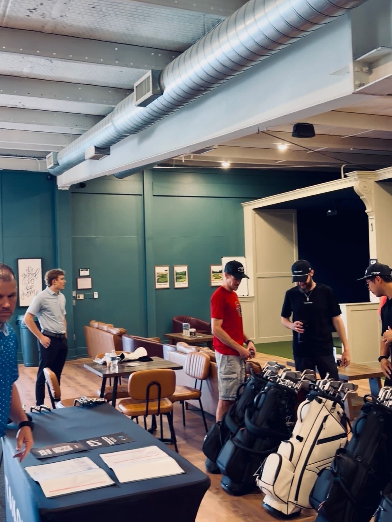 Golfers testing clubs at a Takomo demo day at The Golf House
