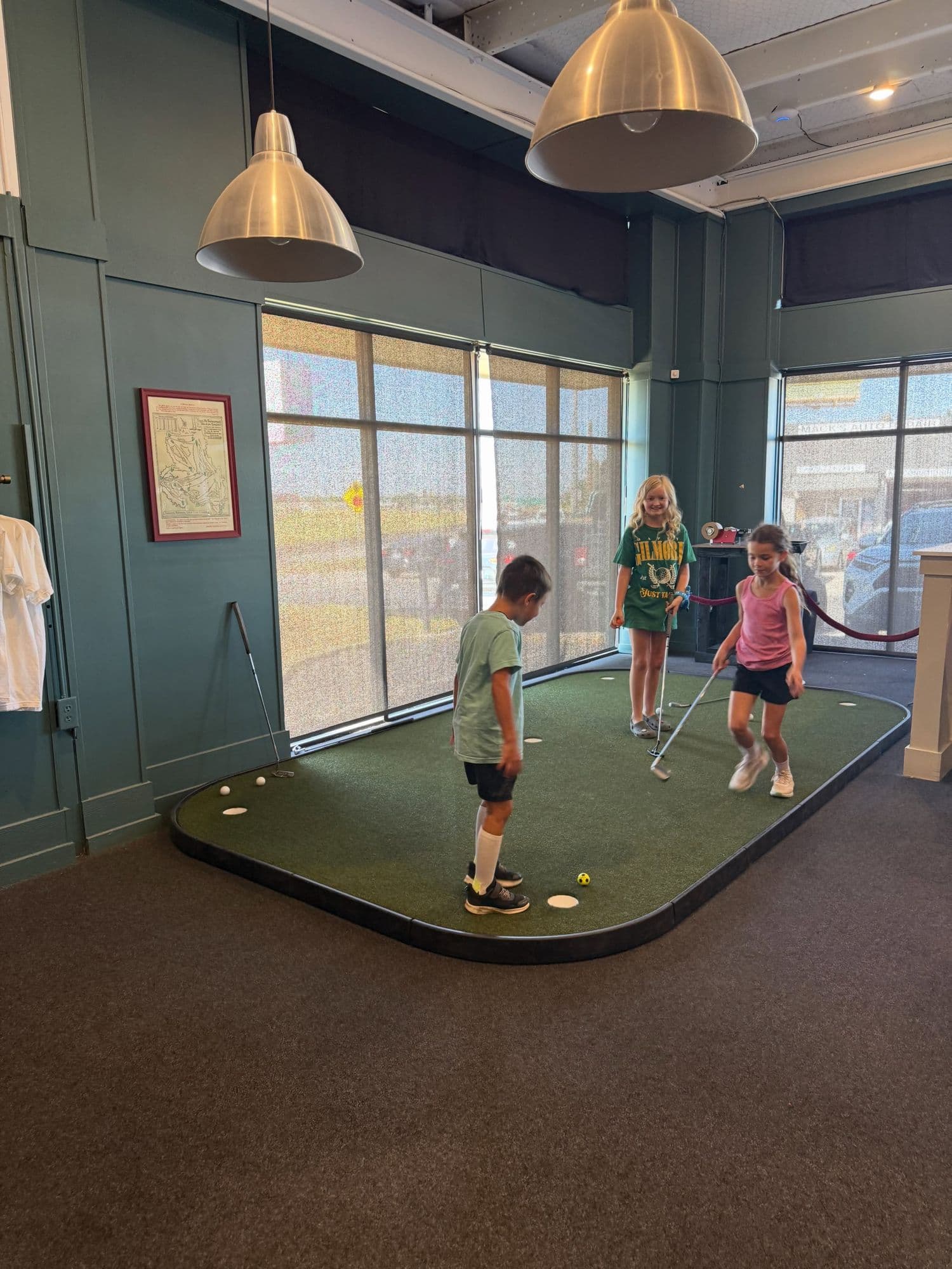 Kids playing on the indoor putting green